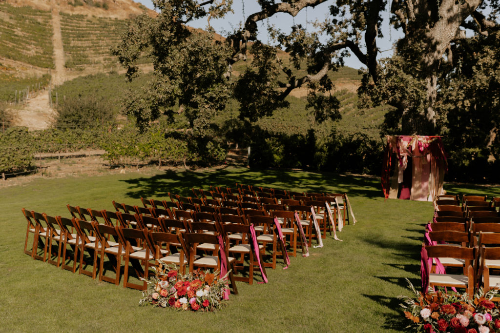 A whimsical wedding at Triunfo Creek Vineyards, wedding ceremony with fabric arch