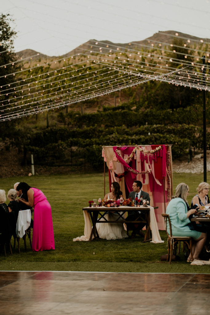 A whimsical wedding reception at Triunfo Creek Vineyards, bride and groom sweet heart table