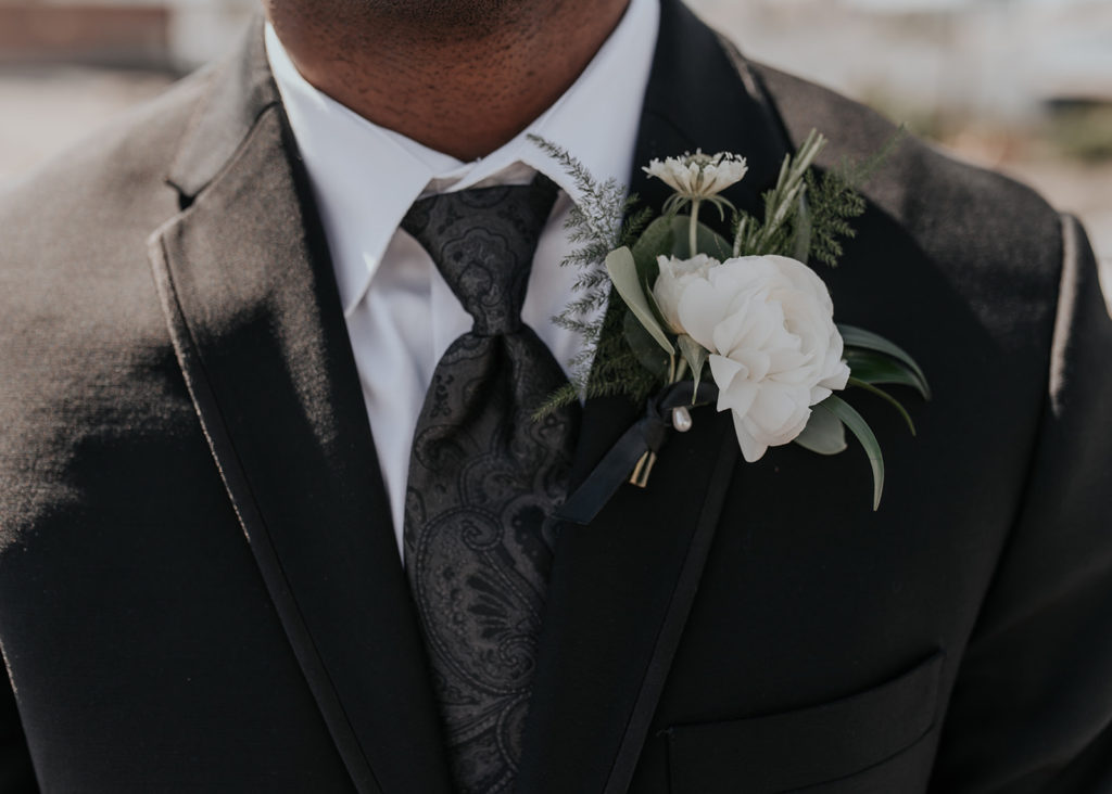 Beautiful wedding at The Unique Space in downtown LA, white flower boutonniere for groom