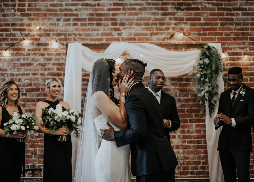 Beautiful wedding at The Unique Space in downtown LA, bride and groom first kiss