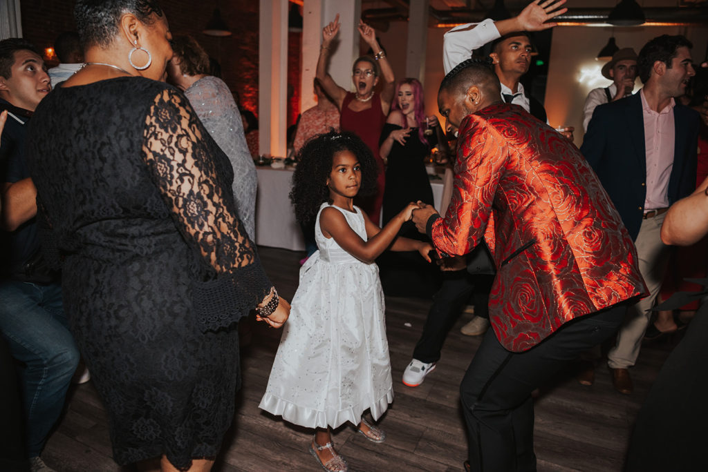 Beautiful wedding at The Unique Space in downtown LA, groom dancing with flower girl