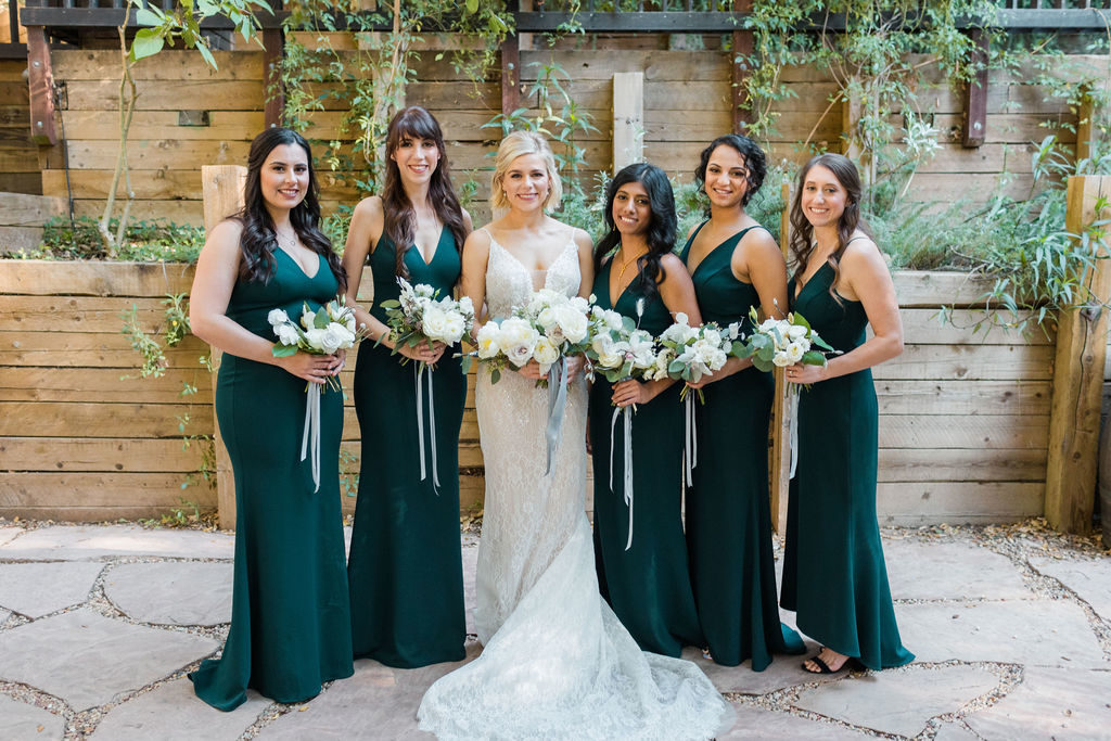 A Romantic Forest Inspired Wedding at the 1909, bride with bridesmaids in deep green dresses