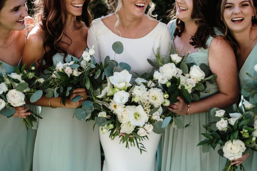 A Classic Vineyard Wedding at Triunfo Creek Vineyards, bride with bridesmaids in sage green dresses, green and white bouquets