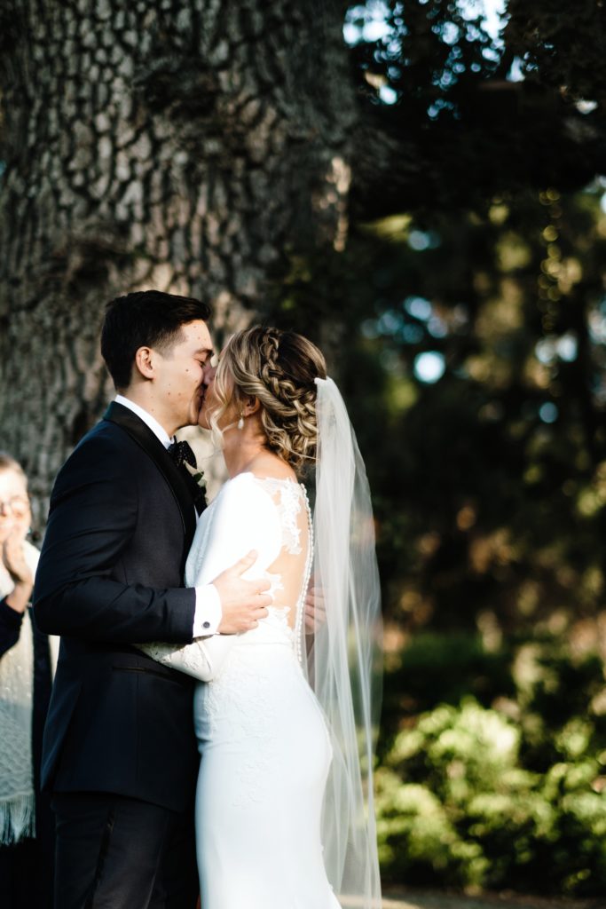 A Classic Vineyard Wedding ceremony at Triunfo Creek Vineyards, bride and groom first kiss