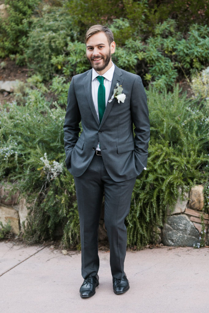 A Romantic Forest Inspired Wedding at the 1909, groom portrait shot in dark grey suit and green tie