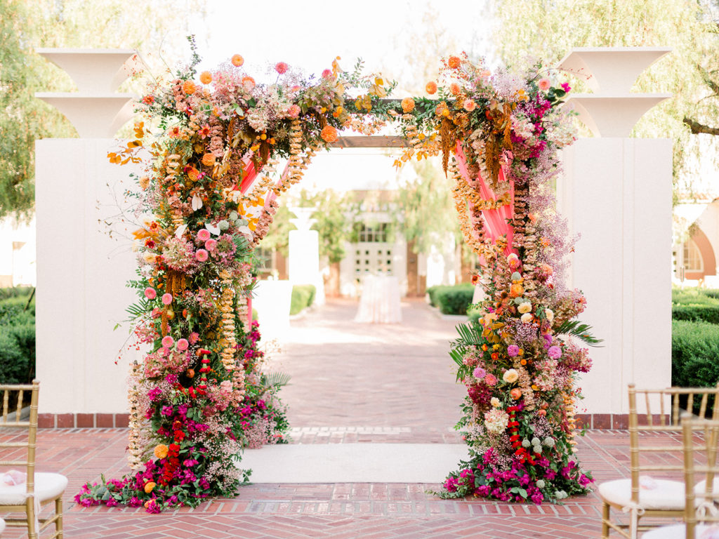 Union Station Wedding ceremony, gold chiavari chairs, colorful floral ceremony arch