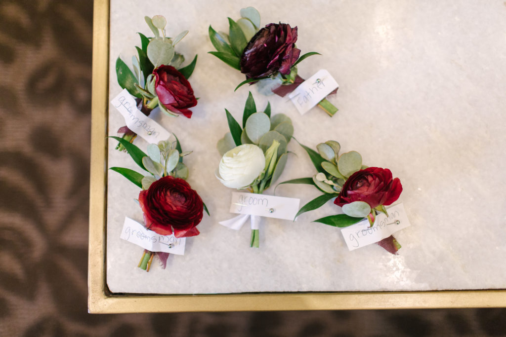 A Fall Wedding at Calamigos Ranch, red and white groomsmen boutonnieres 