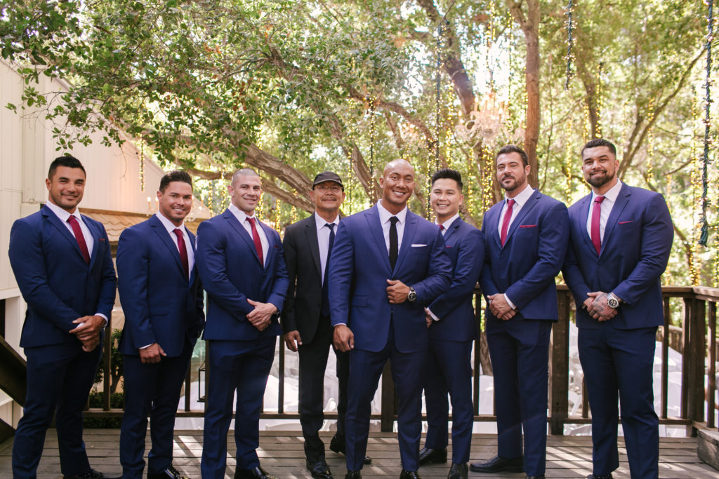 A Fall Wedding at Calamigos Ranch, groom and groomsmen in dark blue suits with red ties
