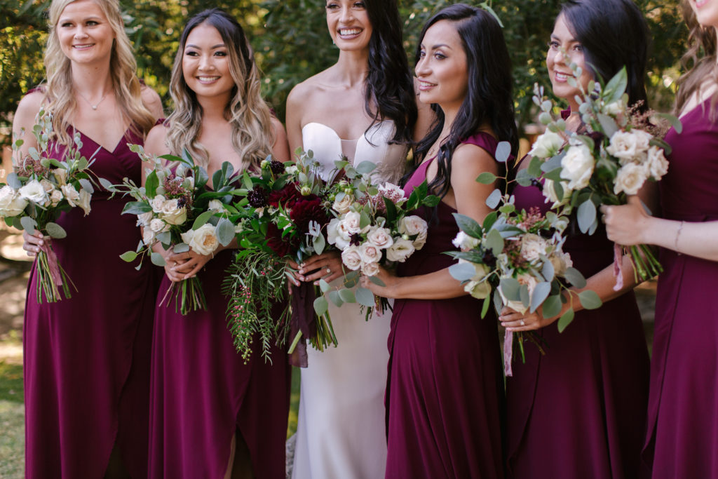 A Fall Wedding at Calamigos Ranch, bride and groom with wedding party, bridesmaids in dark burgundy dresses