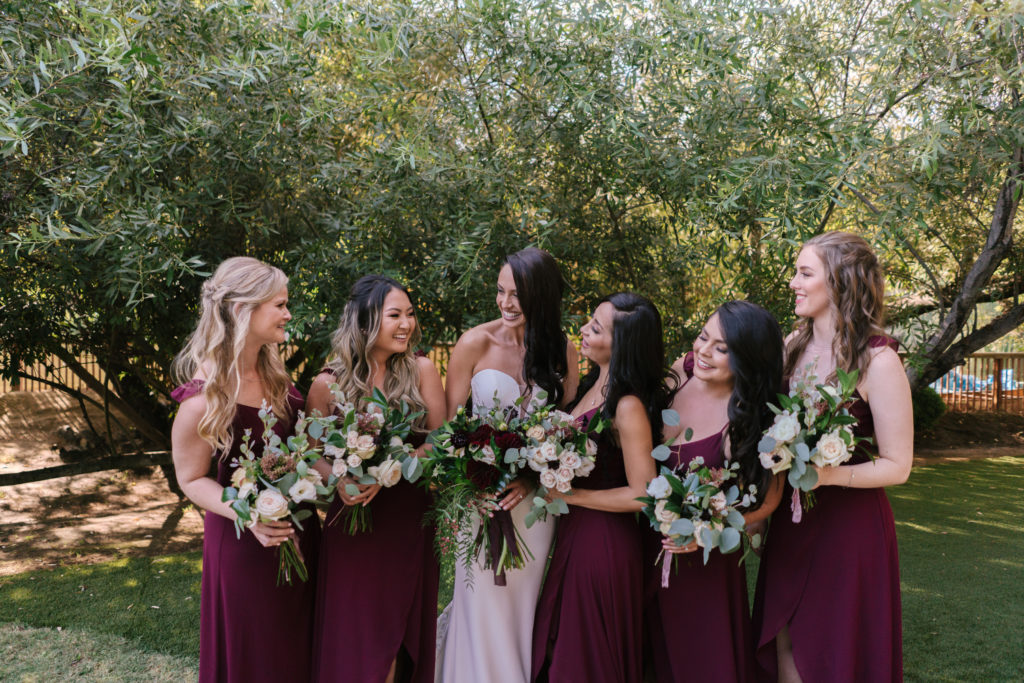 A Fall Wedding at Calamigos Ranch, bride and groom with wedding party, bridesmaids in dark burgundy dresses