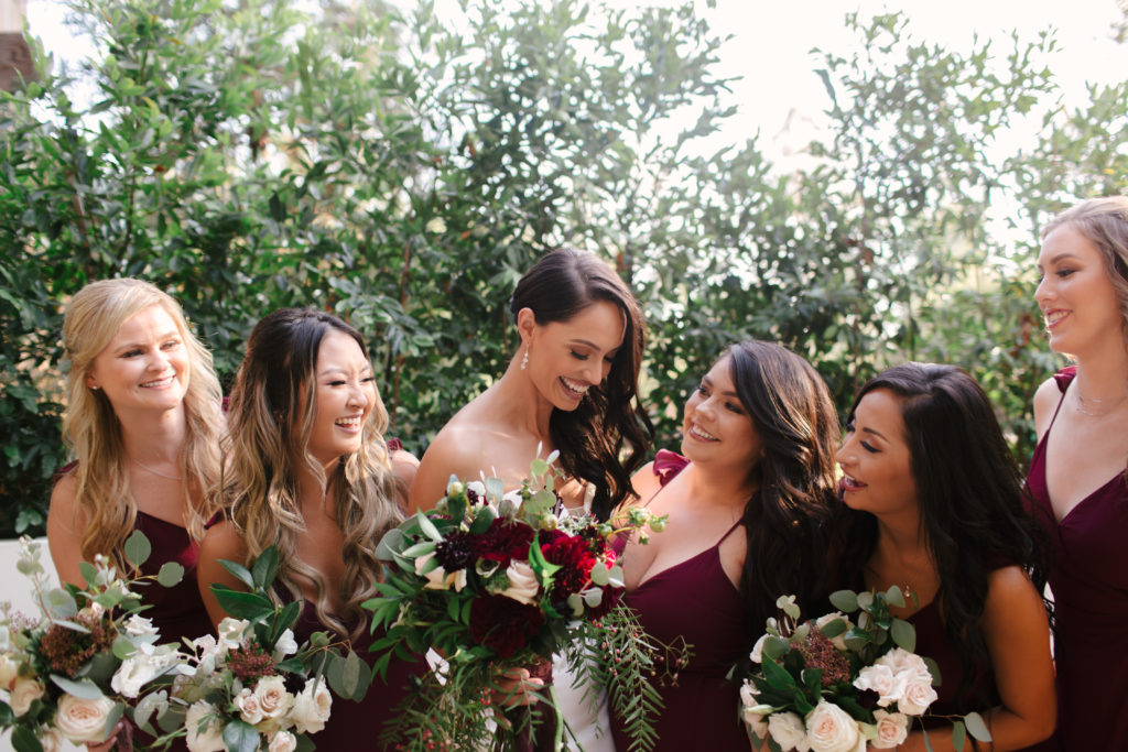 A Fall Wedding at Calamigos Ranch, bride with bridesmaids in deep burgundy bridesmaid dresses
