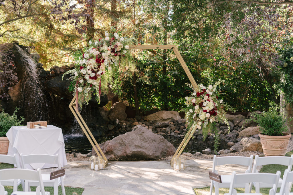 A Fall Wedding ceremony at Calamigos Ranch, gold hexagon ceremony arch