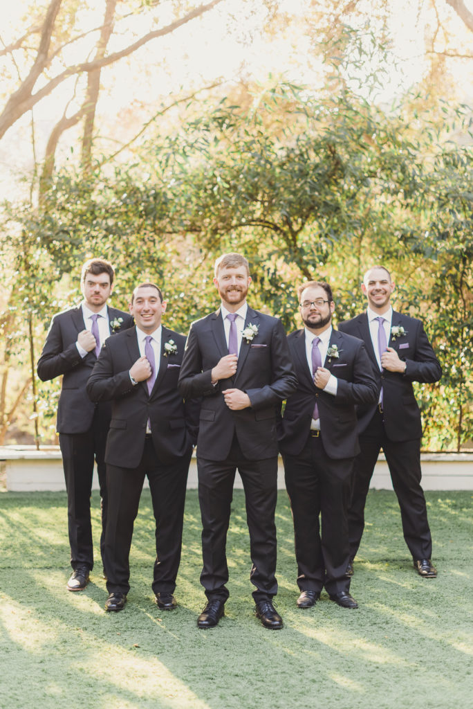 A Springtime Malibu Wedding at Calamigos Ranch, groom and groomsmen in dark grey suits and lilac ties