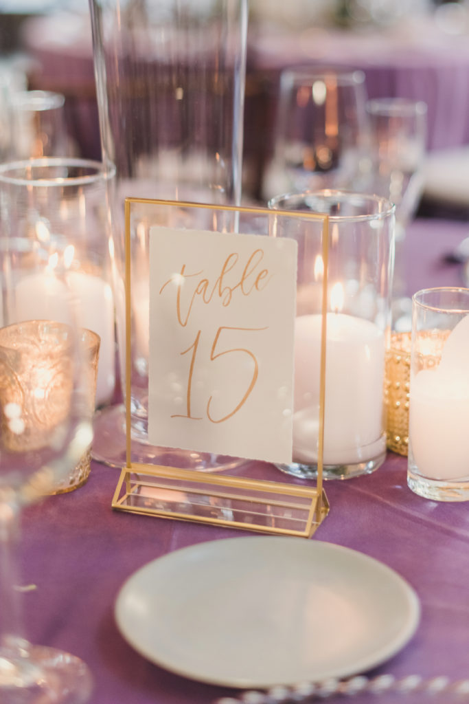 A Springtime Malibu Wedding reception at Calamigos Ranch, Redwood Room with lilac details and gold framed table number