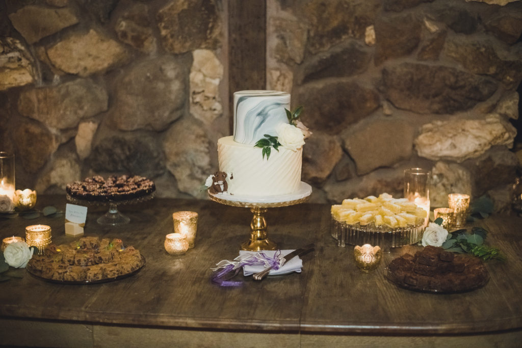 A Springtime Malibu Wedding reception at Calamigos Ranch, blue marble cake on gold cake stand