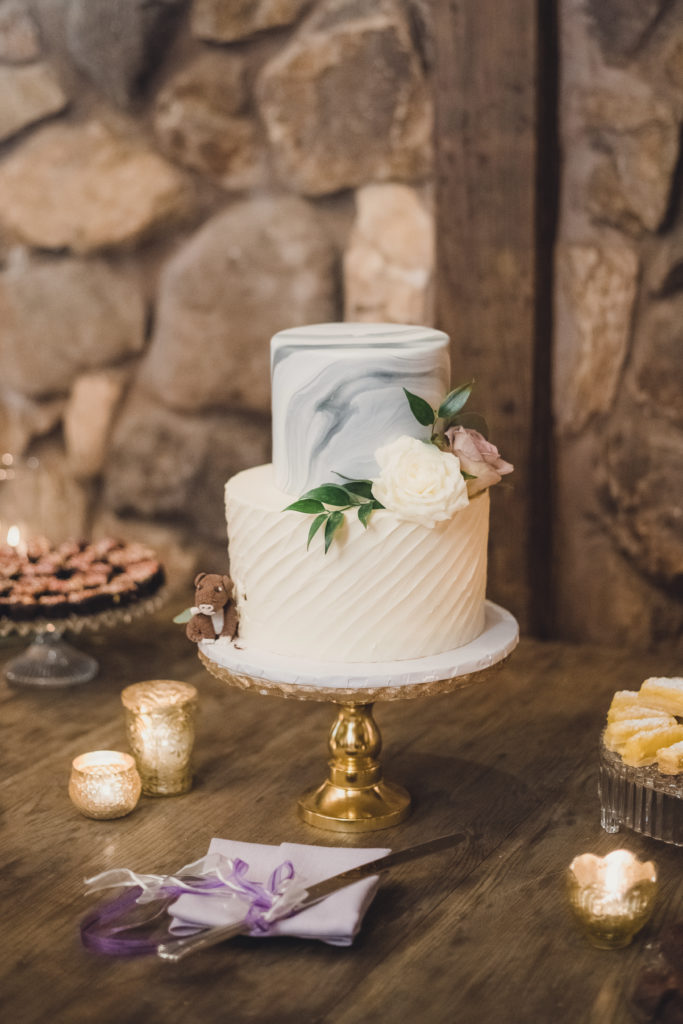 A Springtime Malibu Wedding reception at Calamigos Ranch, marble wedding cake on gold cake stand