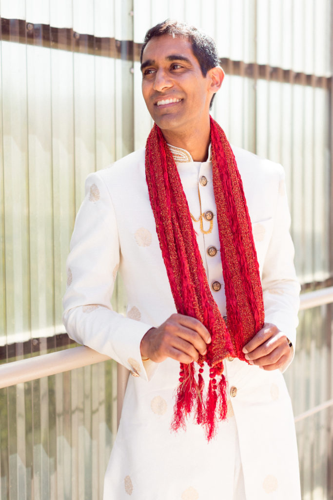 Traditional Indian groom wearing red scarf