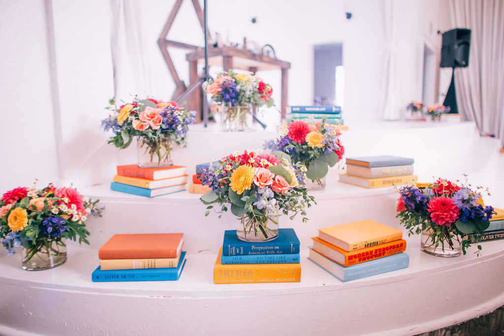 Storybook Themed Wedding at The York Manor, bright book display at the ceremony steps