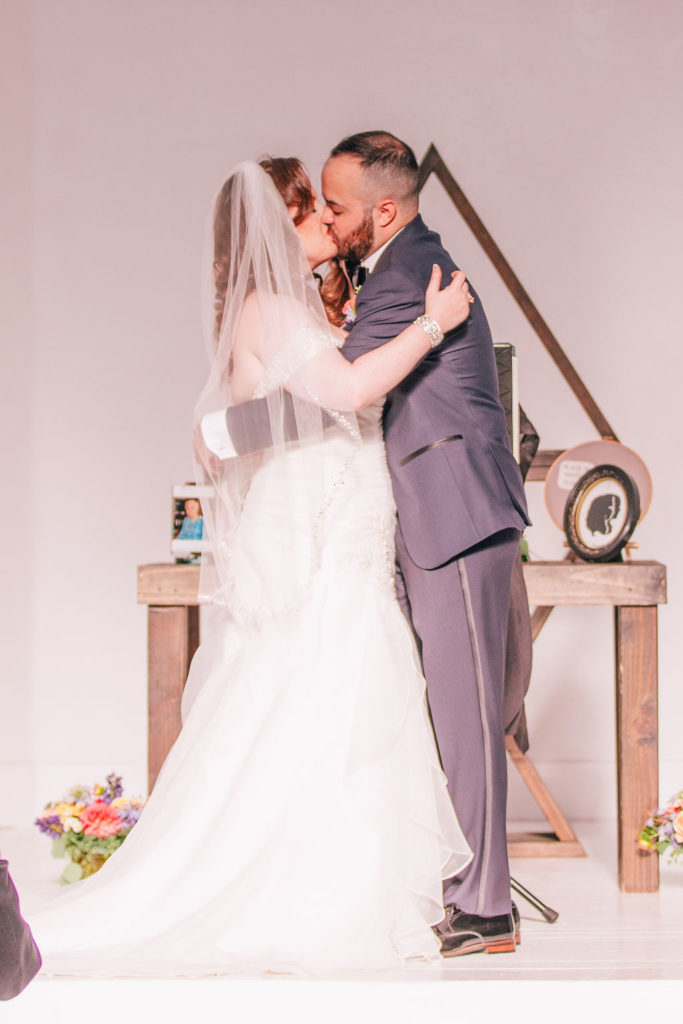 bride and groom first kiss during ceremony at The York Manor