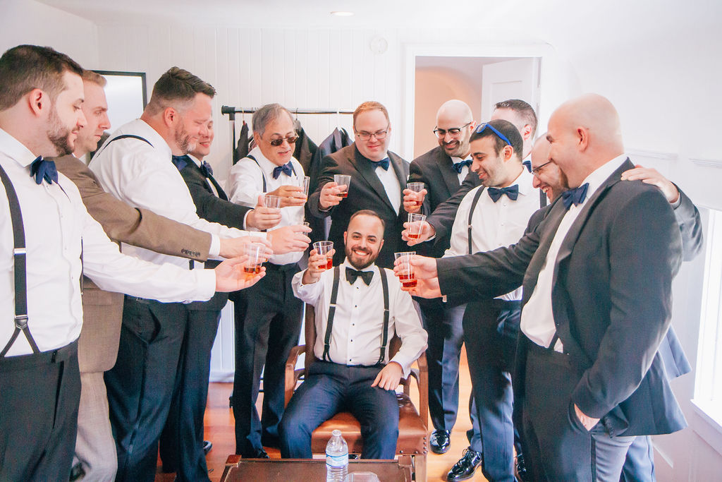 groom getting ready for wedding with groomsmen