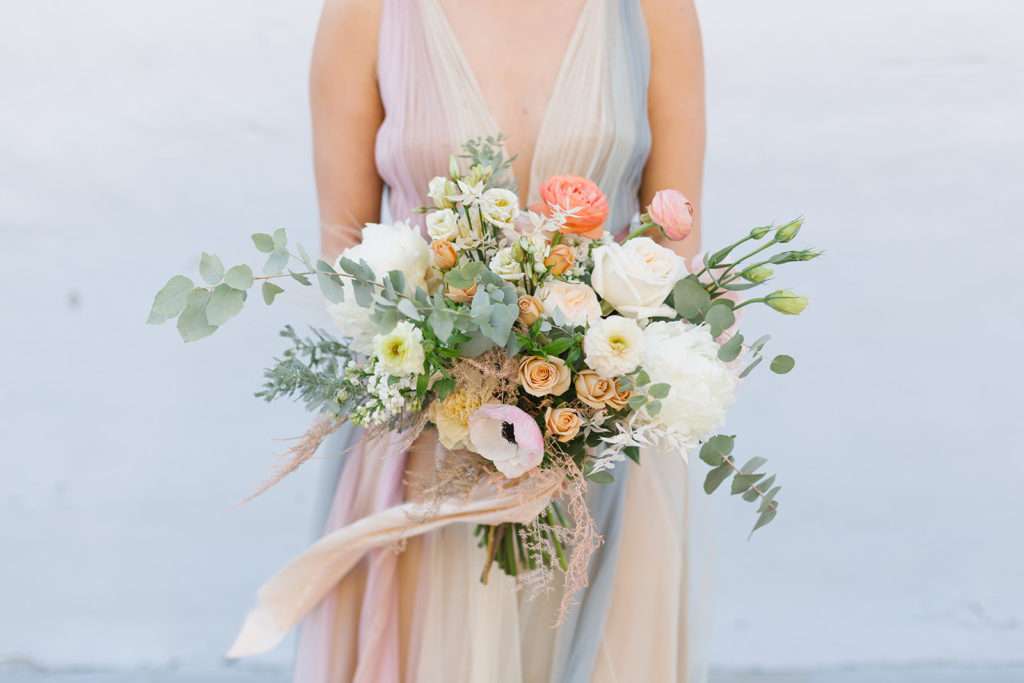 cotton candy inspired styled shoot, bride with pastel colored wedding dress, spring bridal bouquet