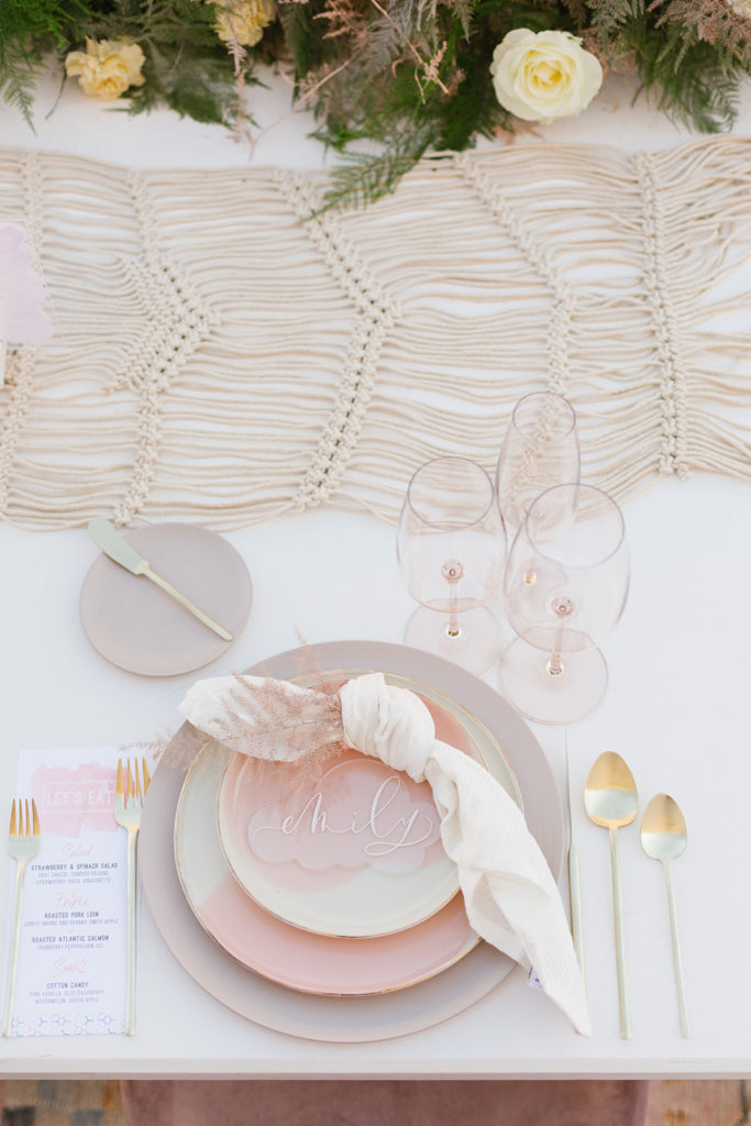 cotton candy inspired styled shoot, wedding reception table set up with clear guest placards and soft pink elements and macrame table runner