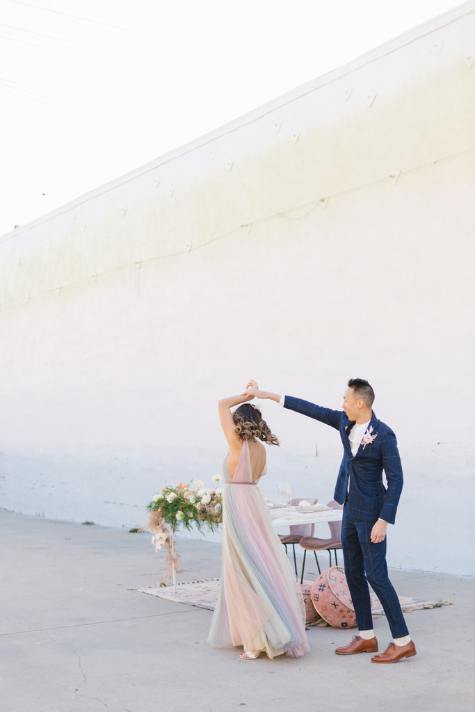 bride in colorful wedding dress and groom dance