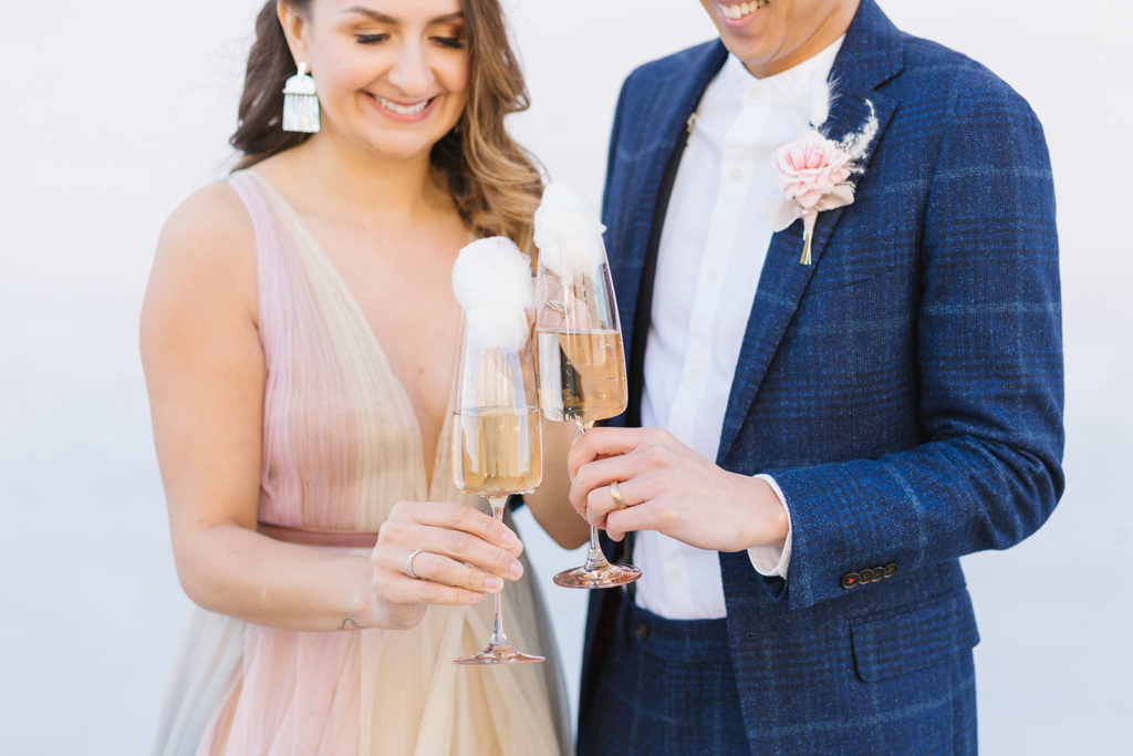 bride and groom with cotton candy topped champagne