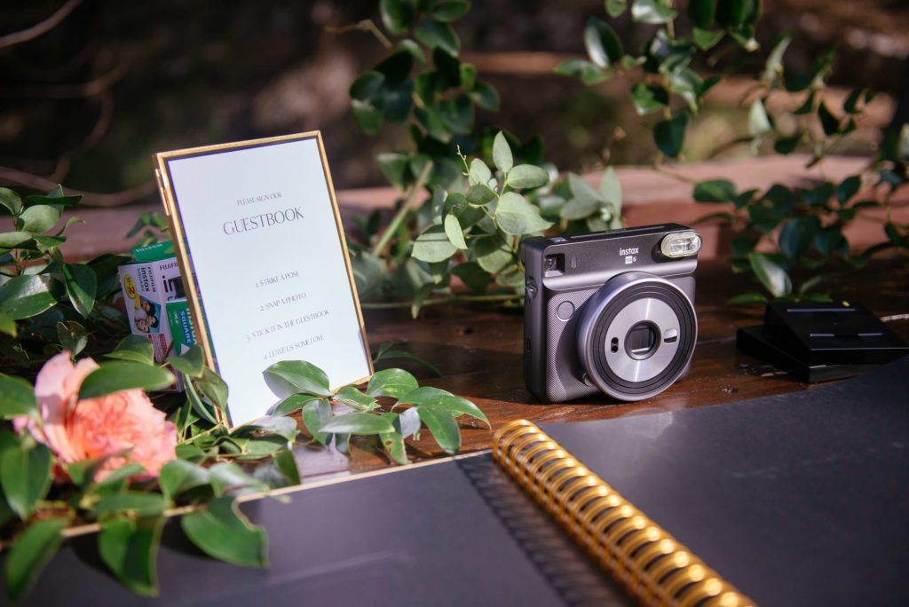 micro wedding at the 1909, wedding welcome table with polaroid guest book