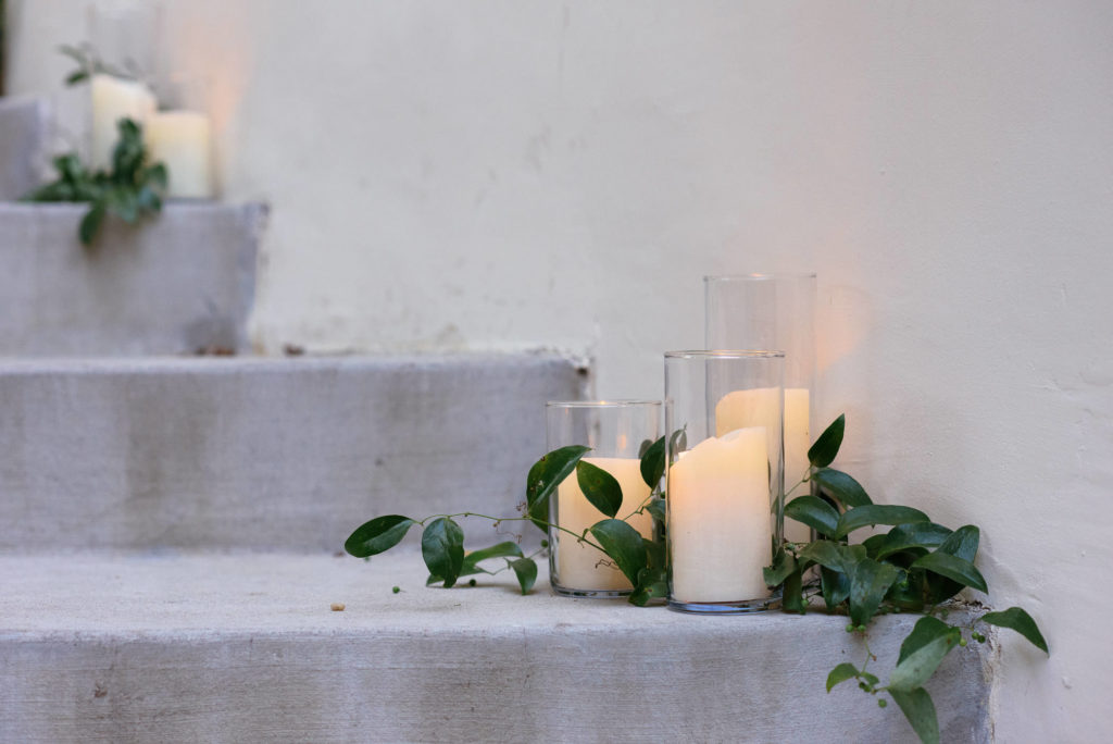 Sophisticated wedding details include candles along every path