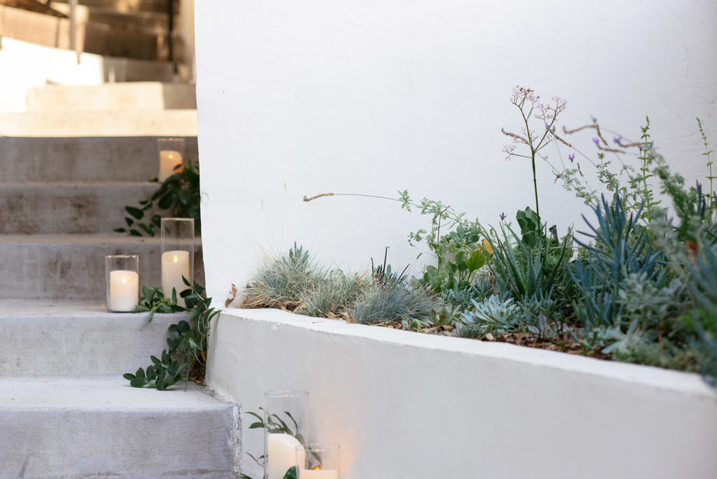 Sophisticated wedding details include candles along every path