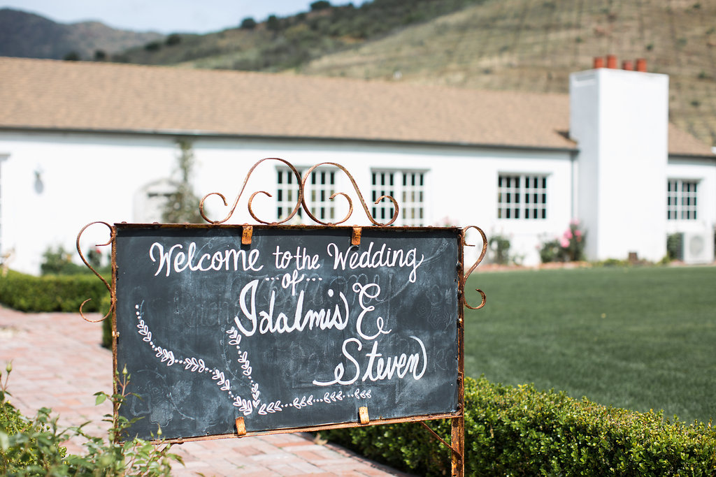 A chalkboard welcome sign for this sweet, small wedding at Triunfo Creek Vineyards