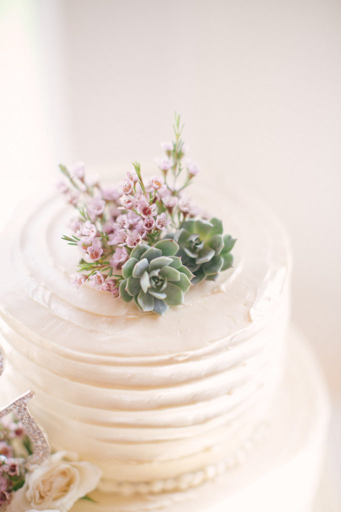 wedding cake topped with succulents