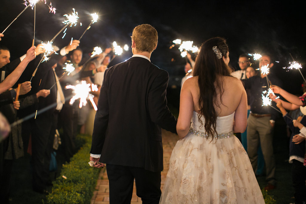bride and groom exit wedding with sparklers