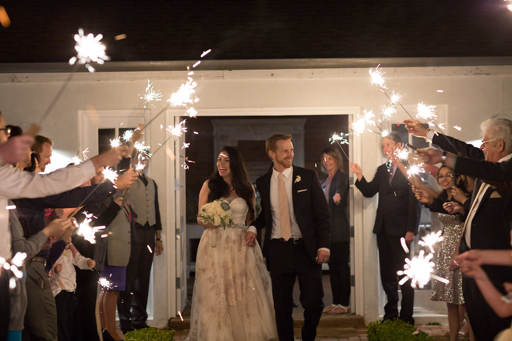 bride and groom exit wedding with sparklers