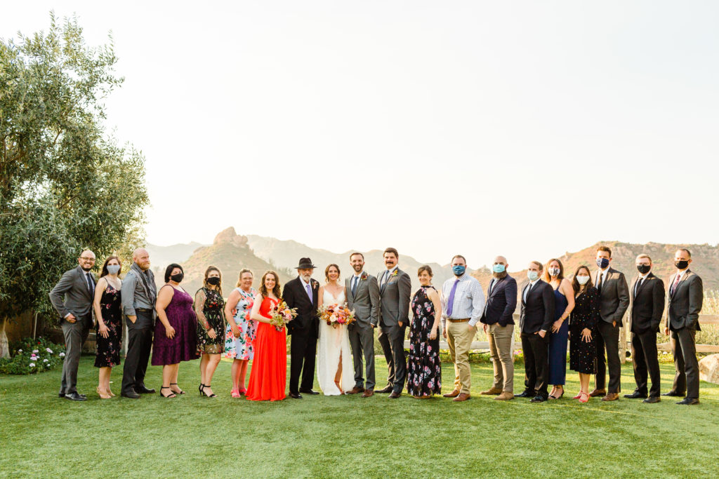 bride and groom portrait shot with all of their guests for their micro wedding at Cielo Farms