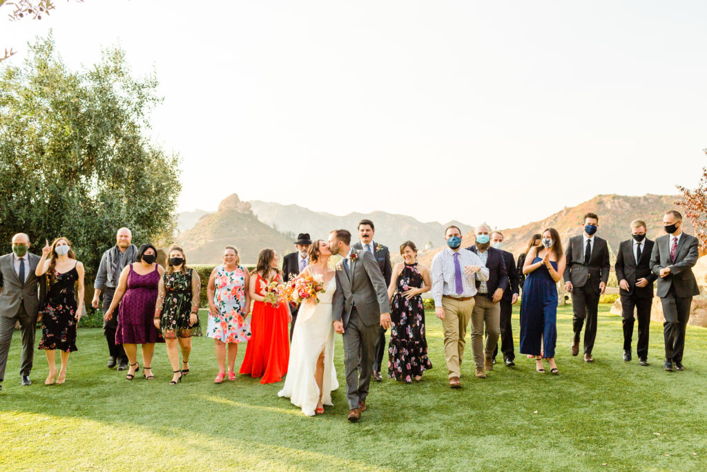 bride and groom portrait shot with all of their guests for their micro wedding at Cielo Farms