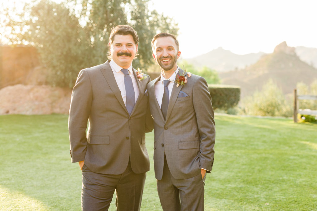 groom and groomsman in grey suit and blue tie