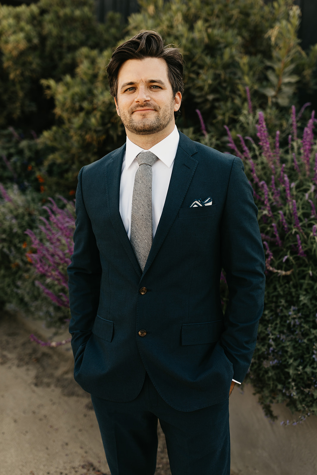 groom in dark blue suit portrait shot at Roblar Winery