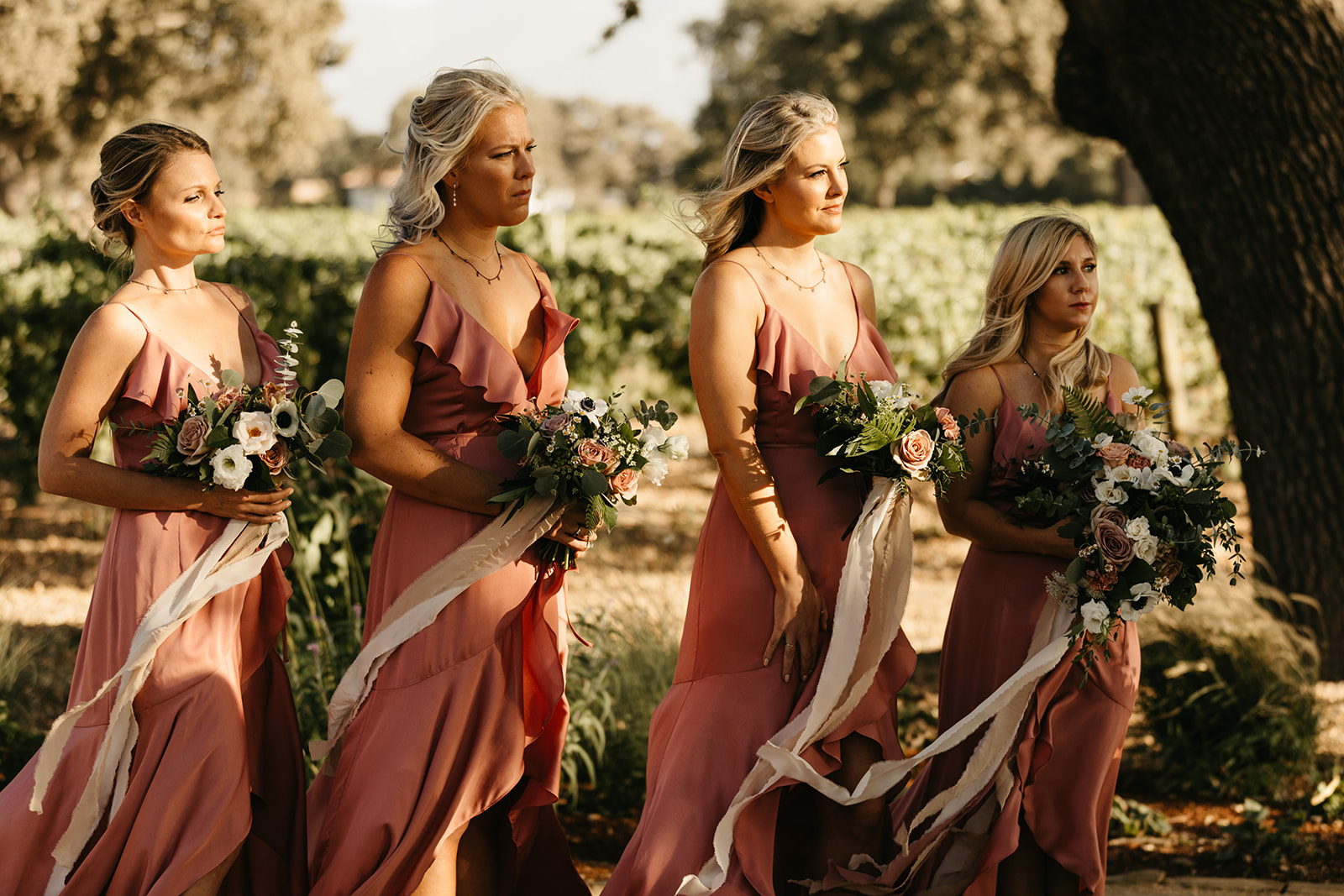 bridesmaids in sunset coral satin dresses 
