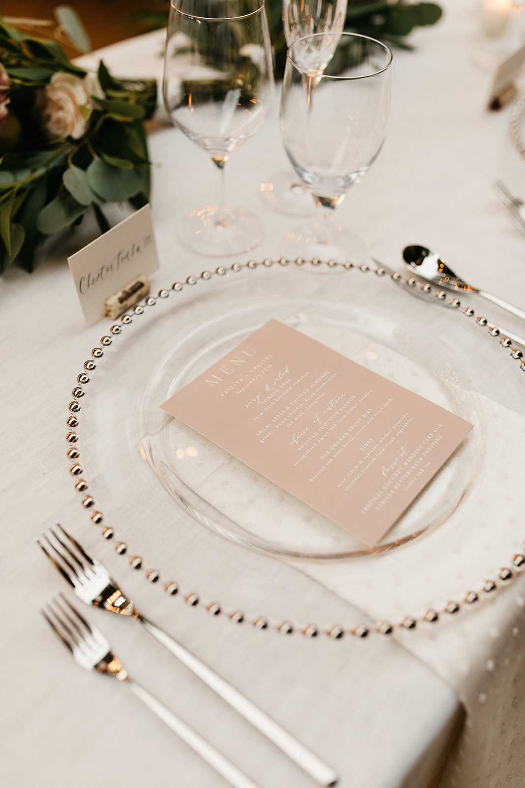 Intimate vineyard wedding reception at Roblar winery with blush pink menus and clear plates