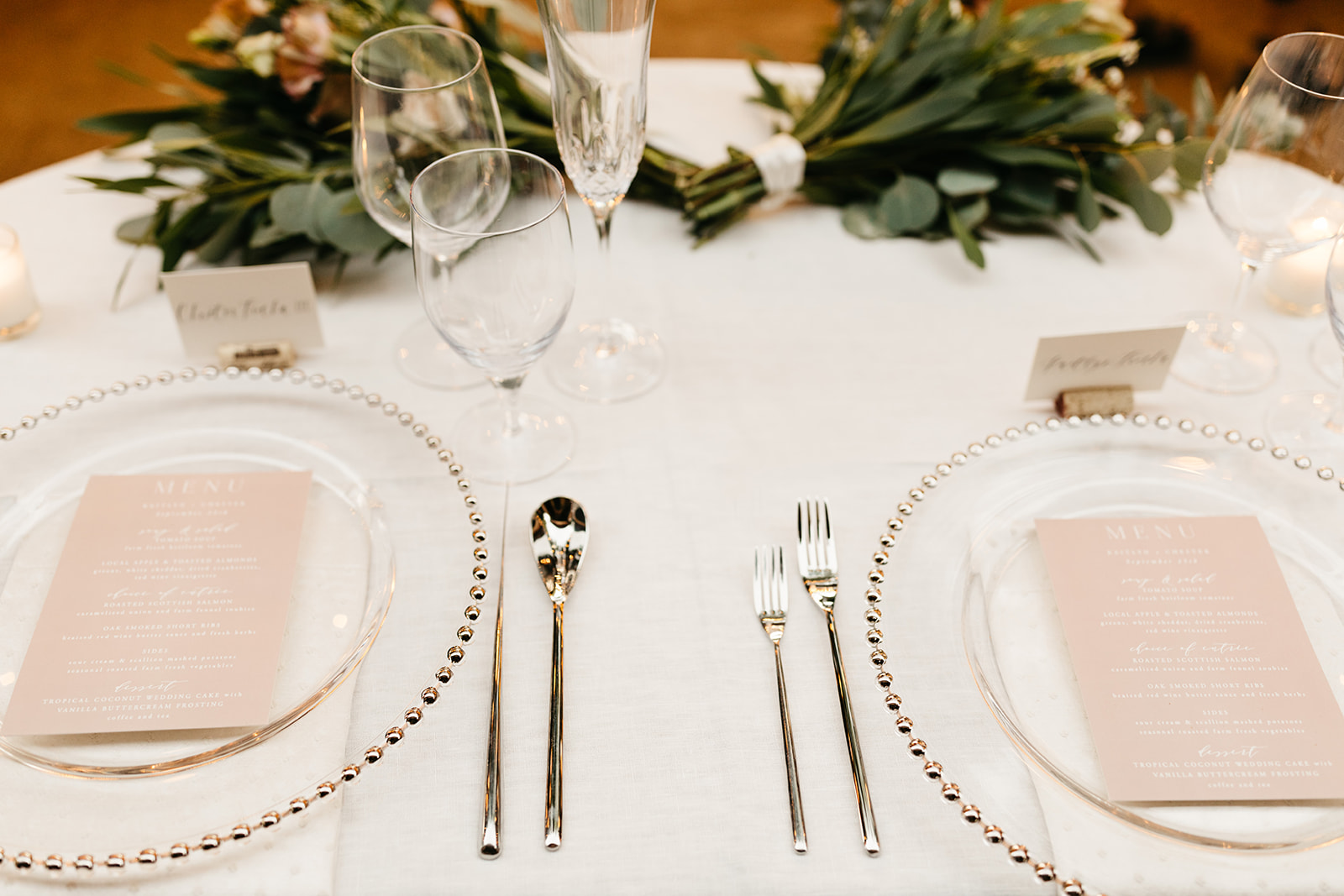 Intimate vineyard wedding reception at Roblar winery with blush pink menus and clear plates
