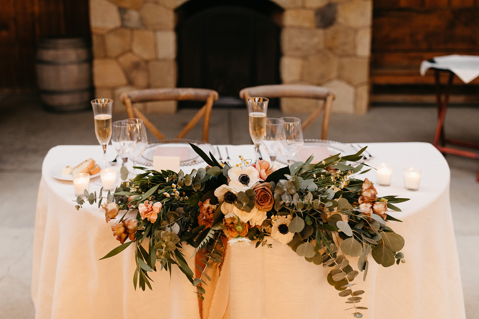 sweetheart table at Roblar Winery with large floral arrangement in front