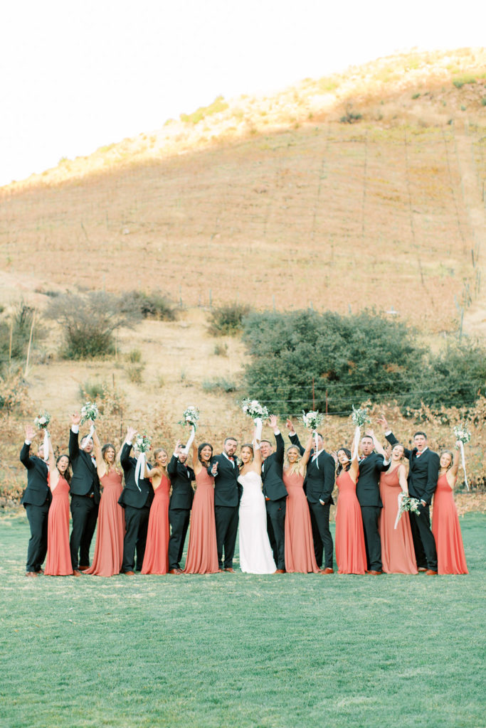 autumn wedding party dresses and suits, portrait shot in vineyard