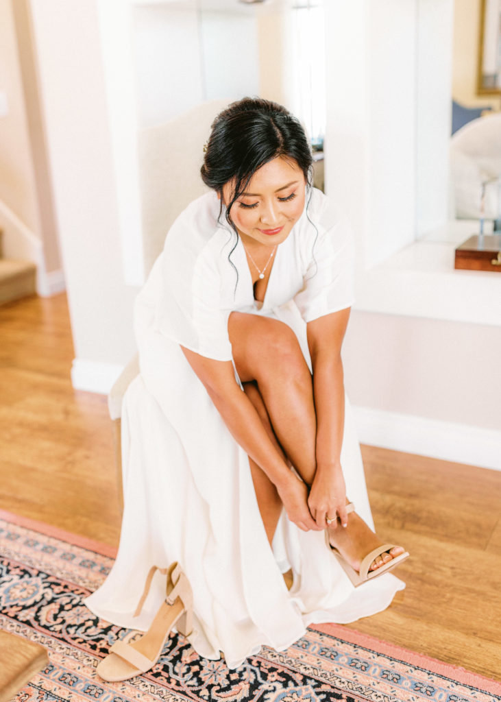 bride getting ready for backyard ceremony at home