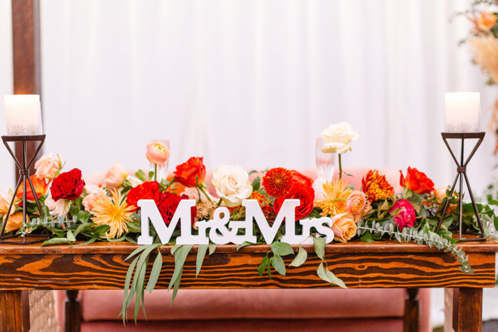 Mr and Mrs sweetheart table sign for a Bohemian style backyard wedding reception