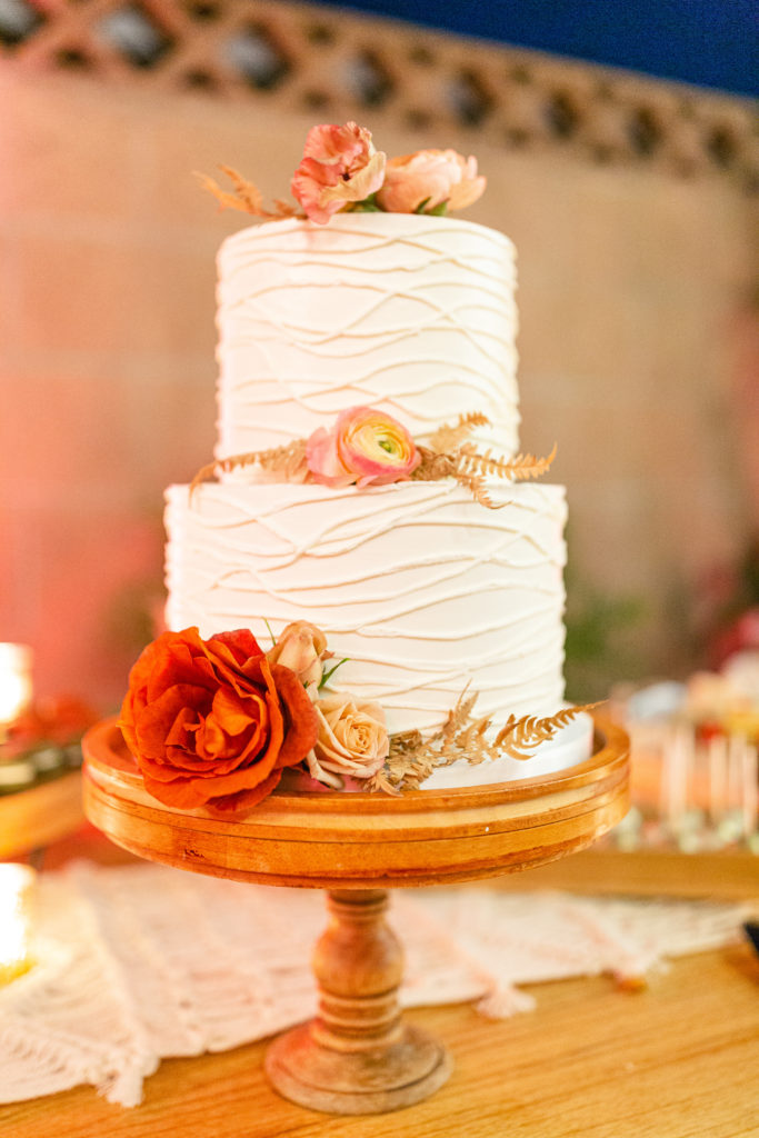 two tier wedding cake with orange florals 