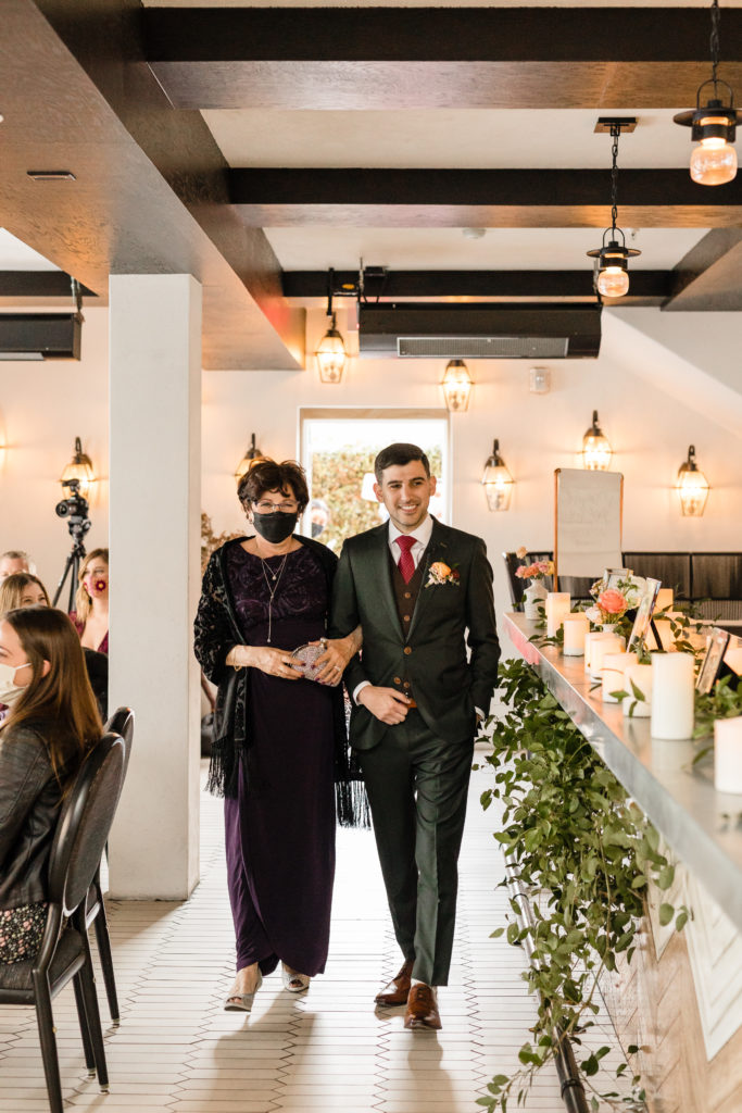 groom walks down aisle with mother at Hotel Figueroa