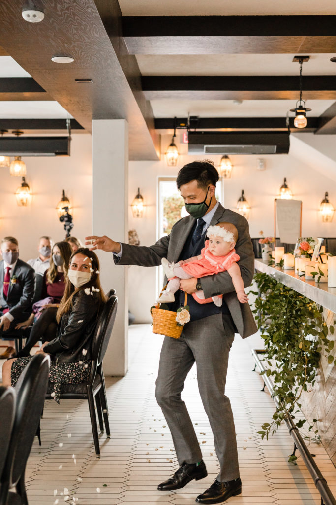 baby flower girl comes down the aisle with father at Hotel Figueroa 