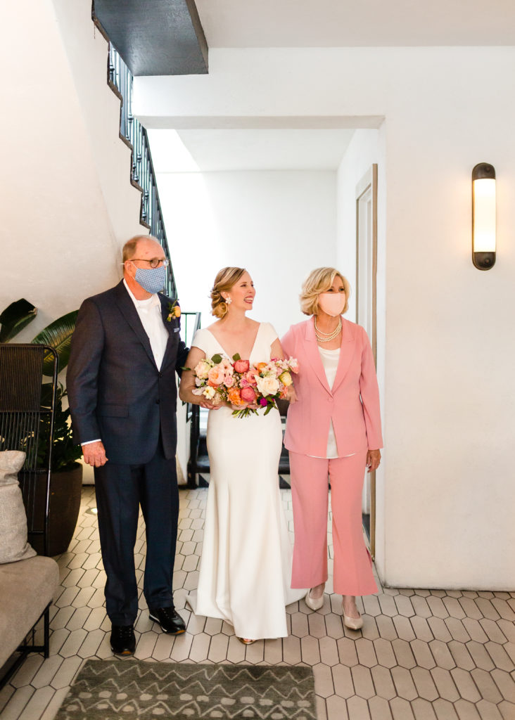 bride walking down aisle with mother and father at Hotel Figueroa